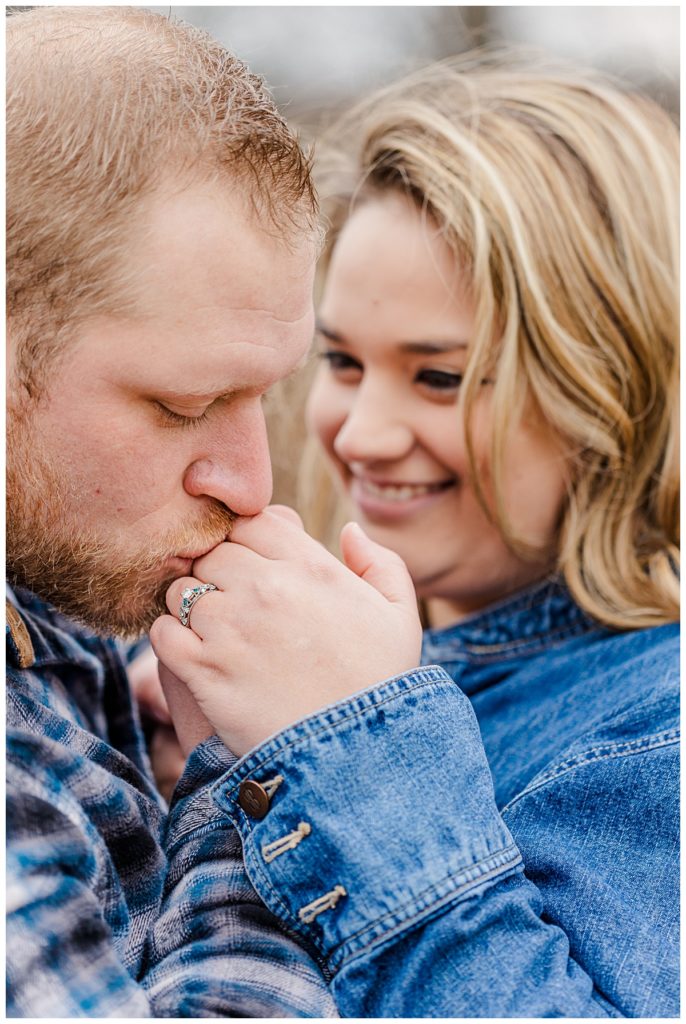Couple posing guy kissing ring hand