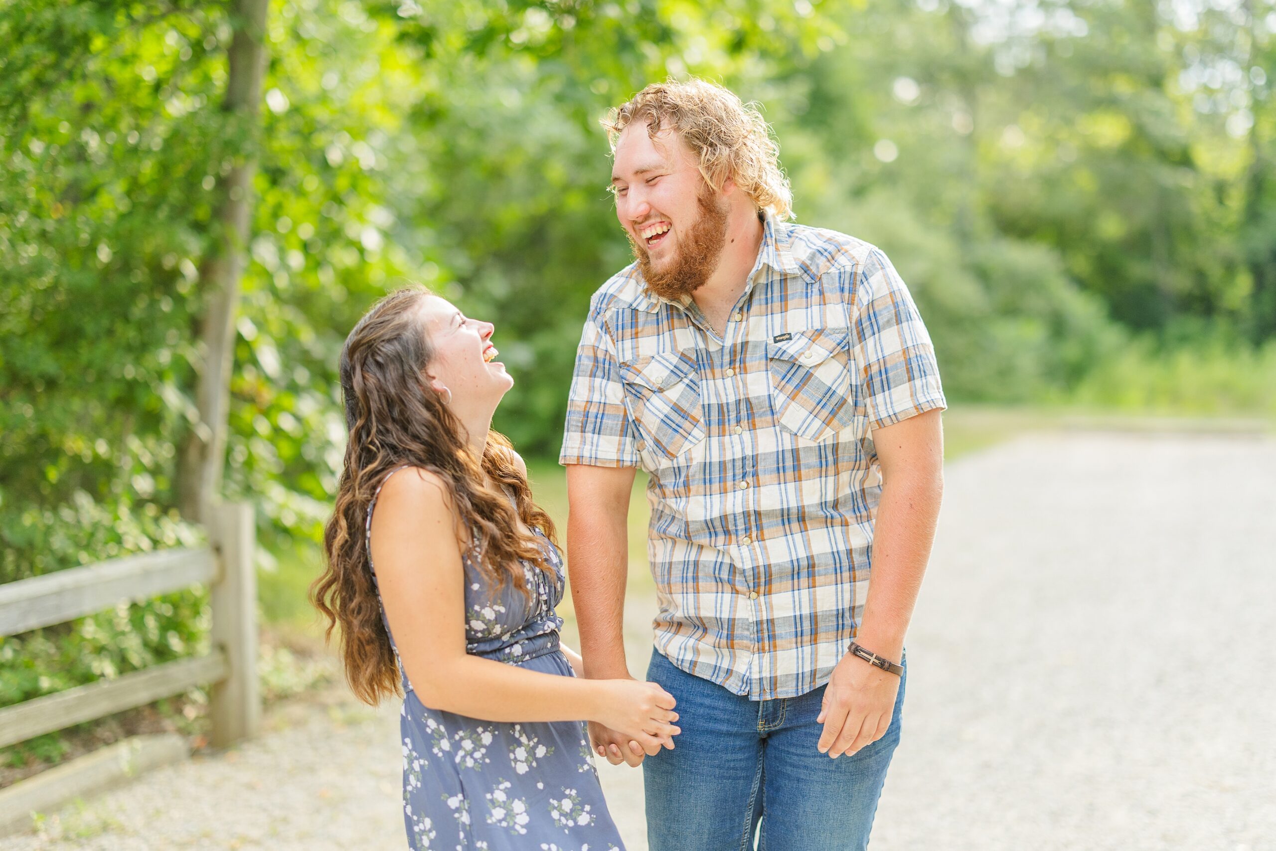 woman and man holding hands while laughing