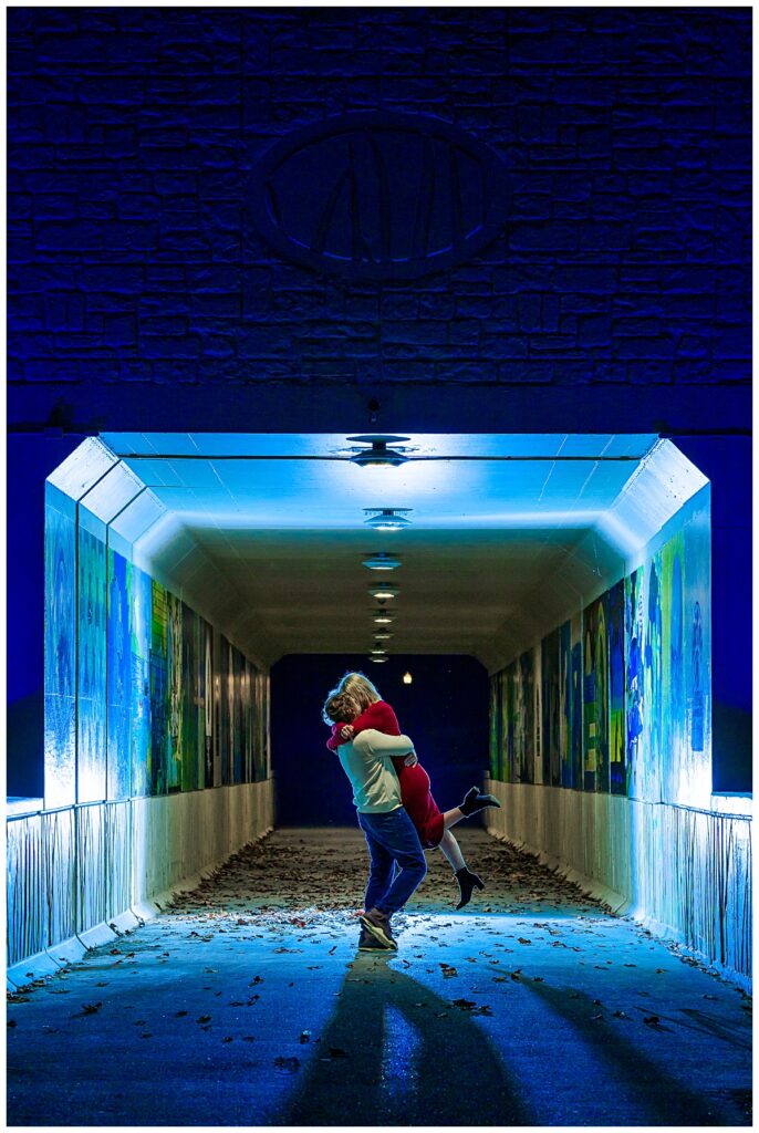 Couple kissing in tunnel during an engagement session.