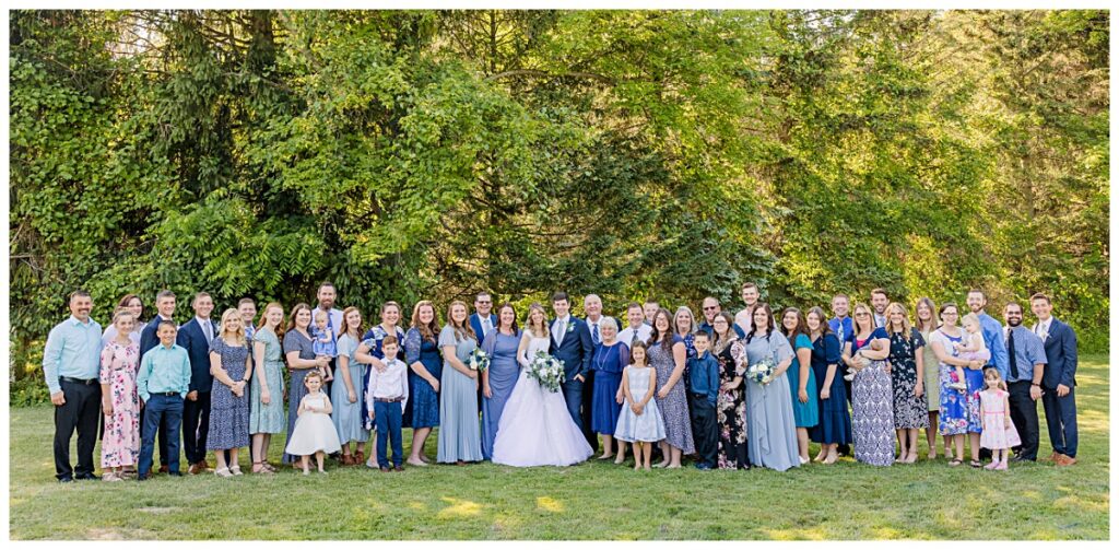 Large family portrait from a wedding with two photographers. 