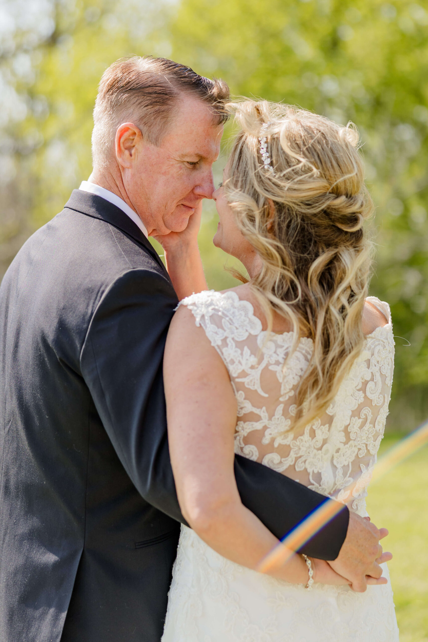 Newlyweds embrace and lean in for a kiss while exploring Trillium farm events
