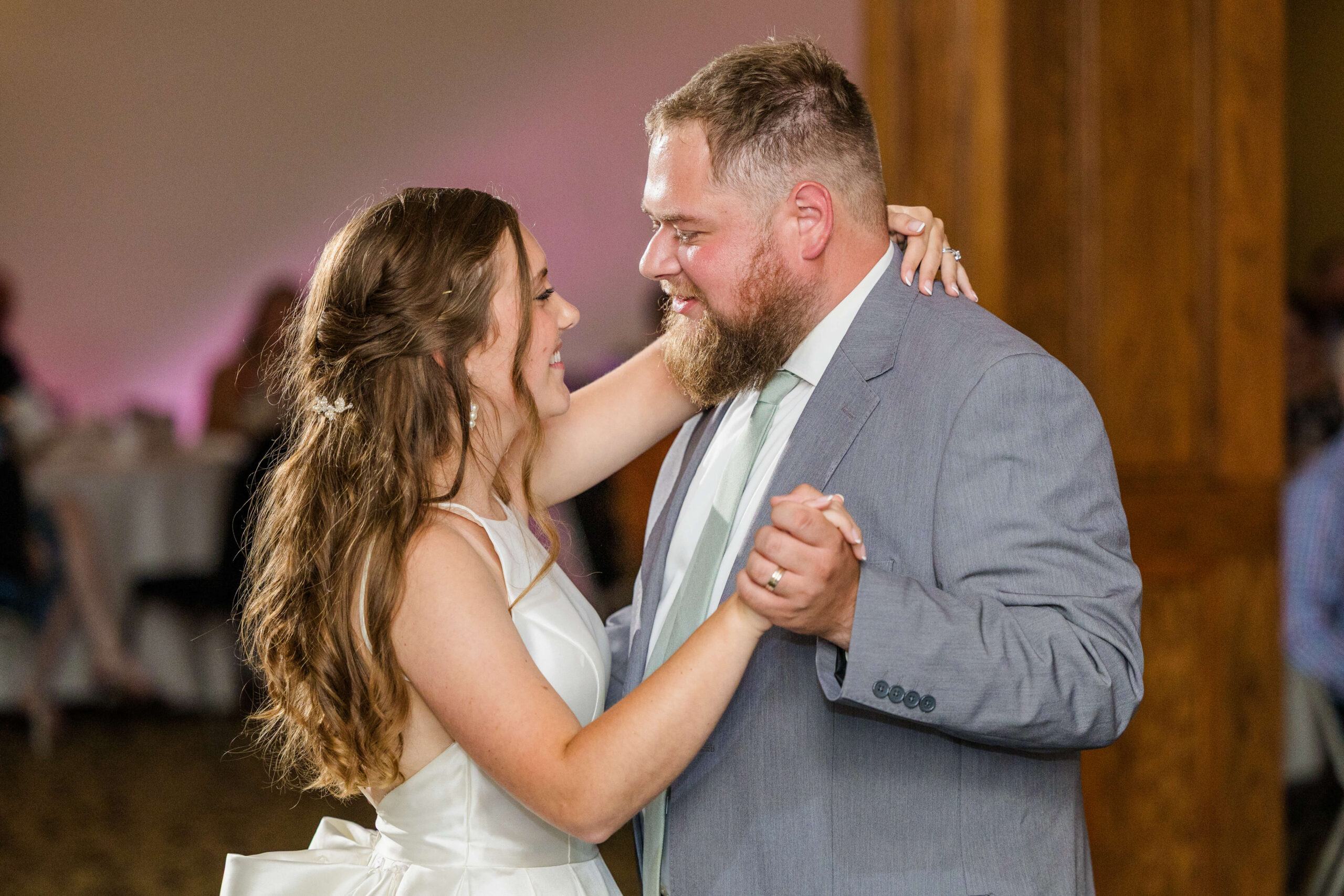 Newlyweds dance and smile at each other