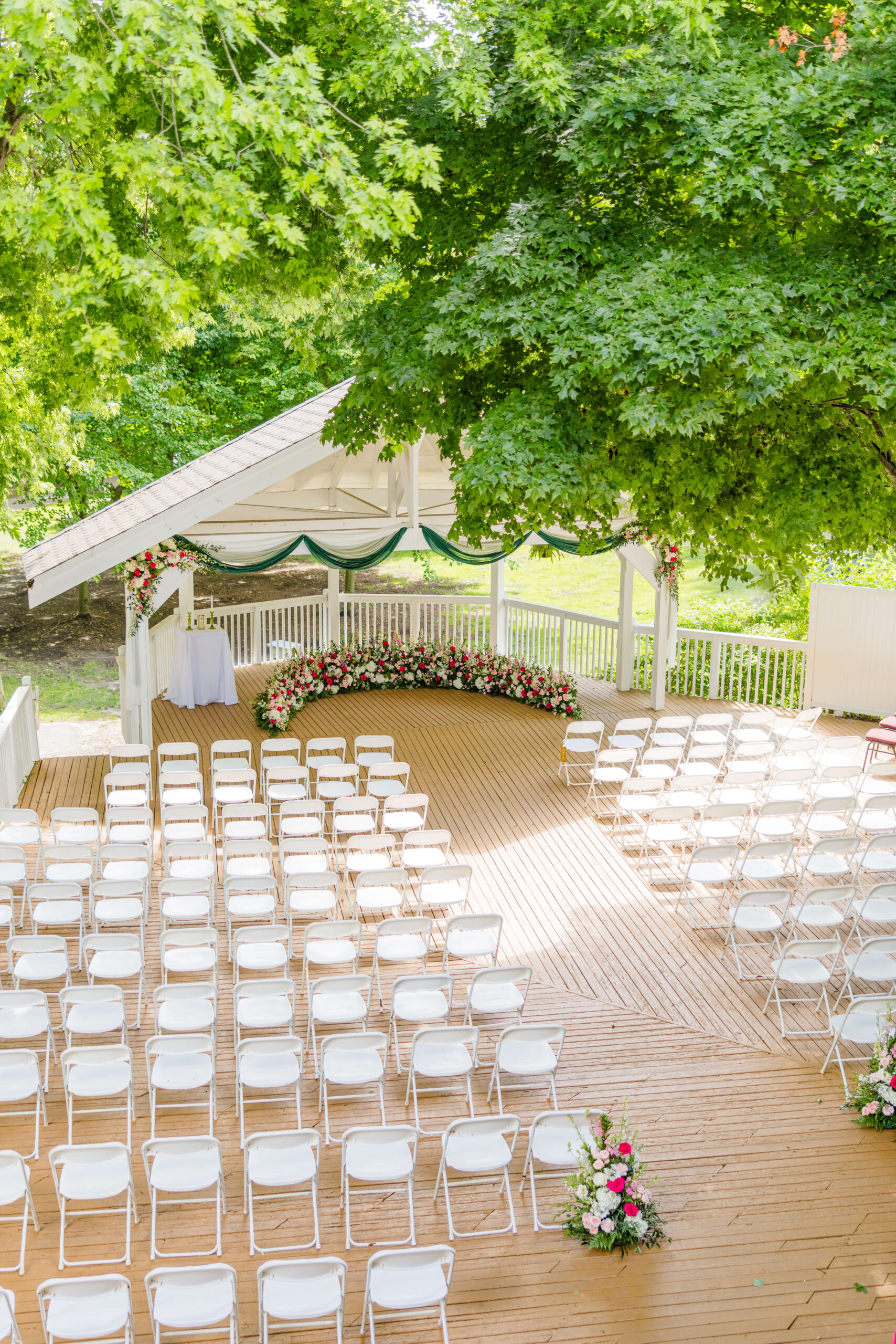 A look down from a balcony to the ceremony deck with white chairs at the golden hawk golf course wedding venue