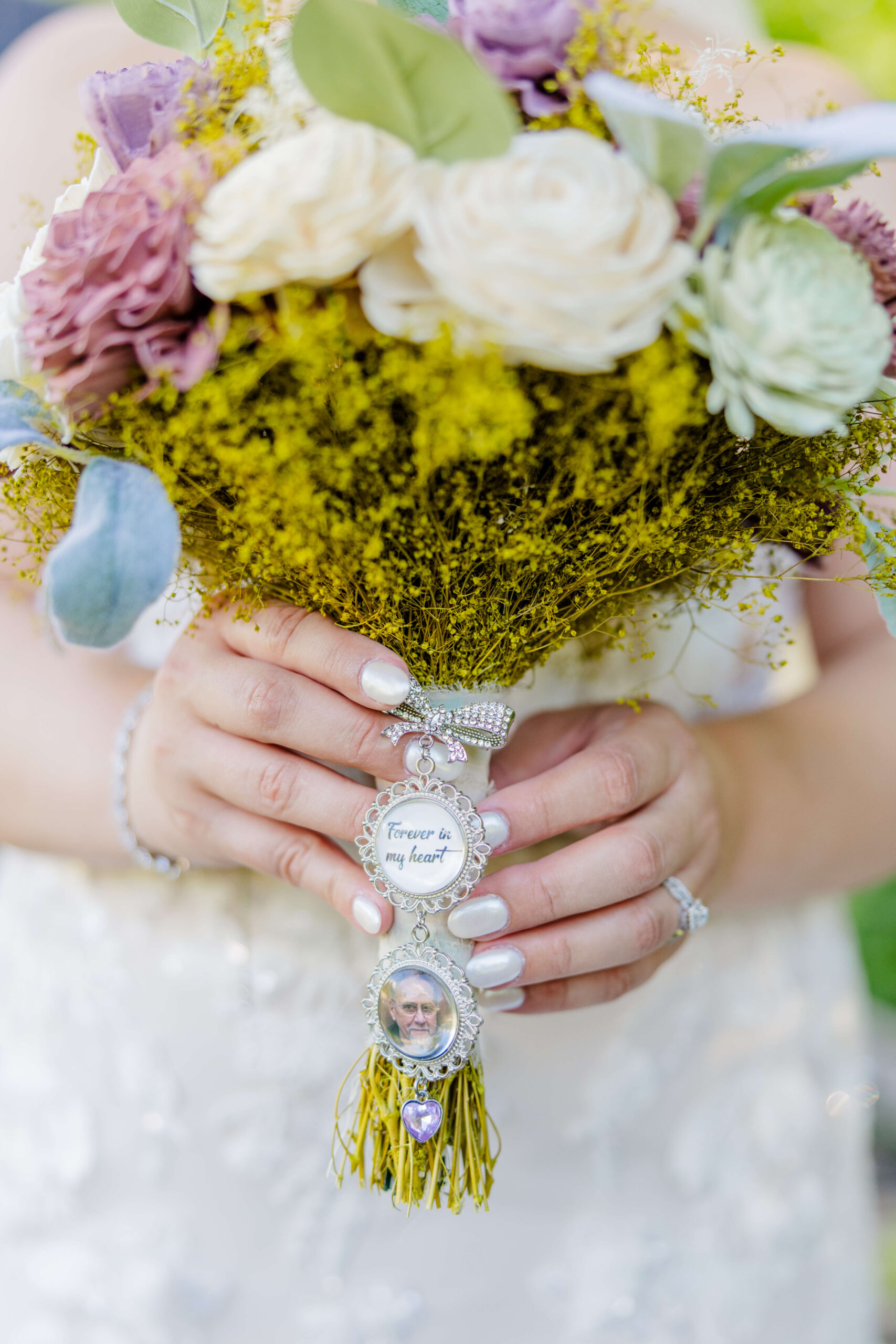 Details of a bride's memorial on her bouquet