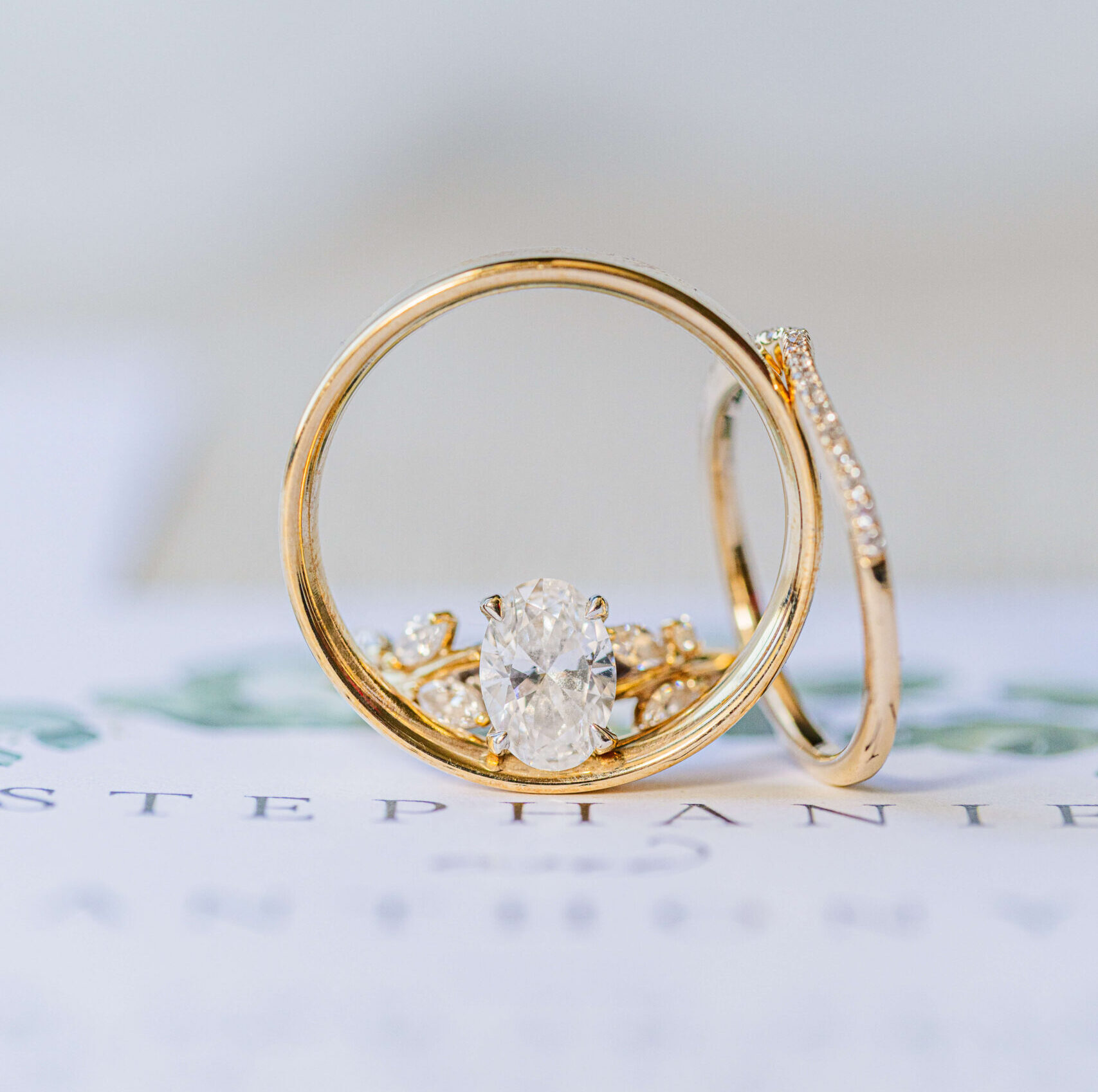 Details of gold wedding rings on an invitation