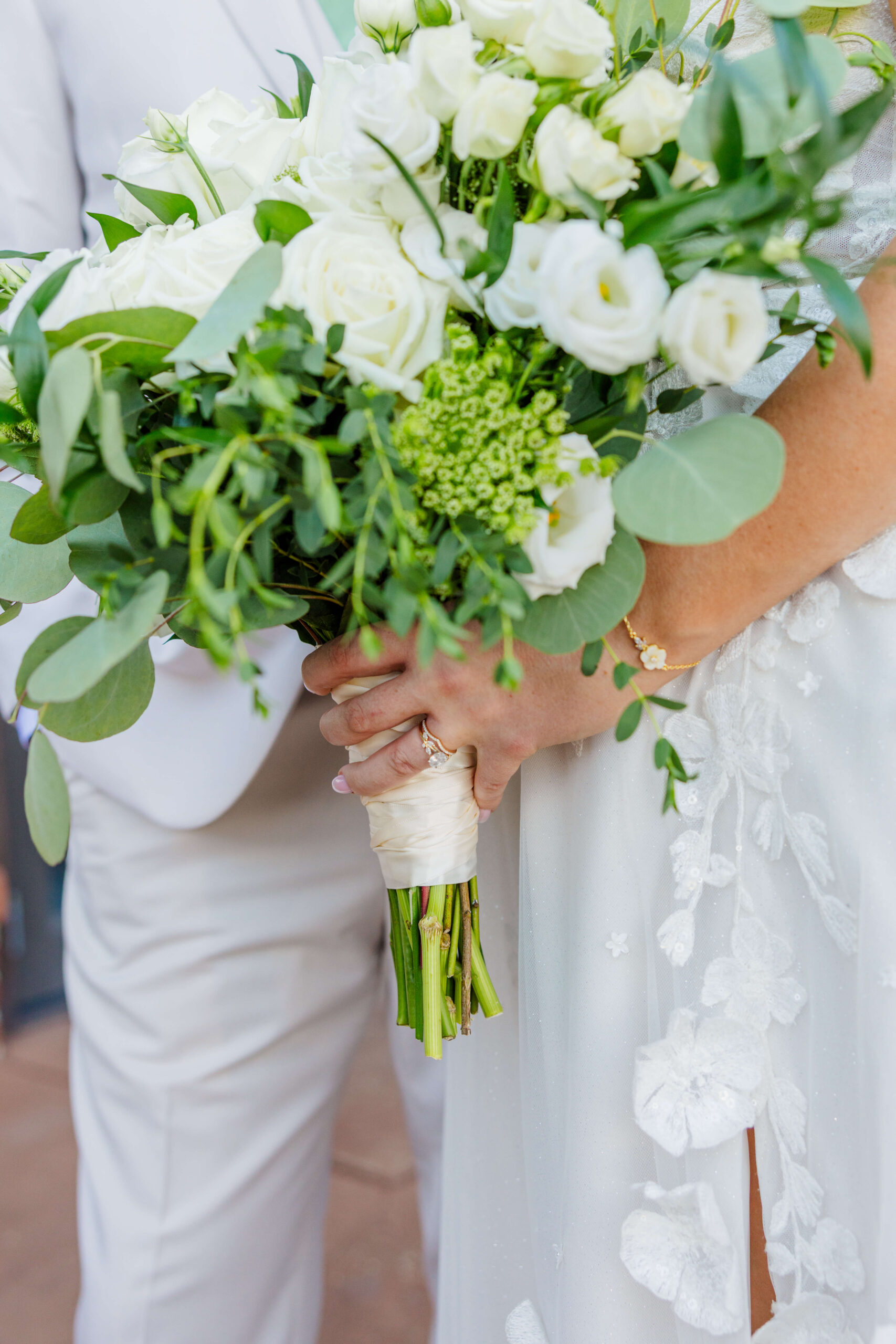 Details of a bride's white bouquet in her hand